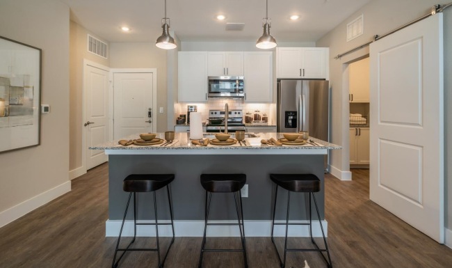 Spacious kitchens with thoughtful details a kitchen with a bar stools