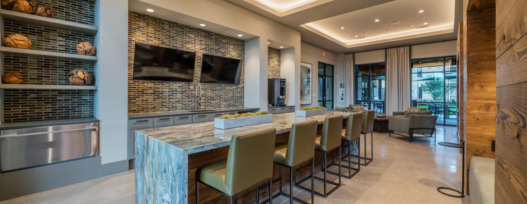 a kitchen with a bar and chairs