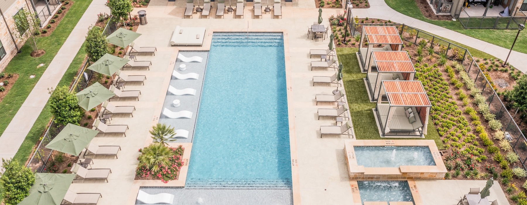 Resort-style swimming pool with lounge seating